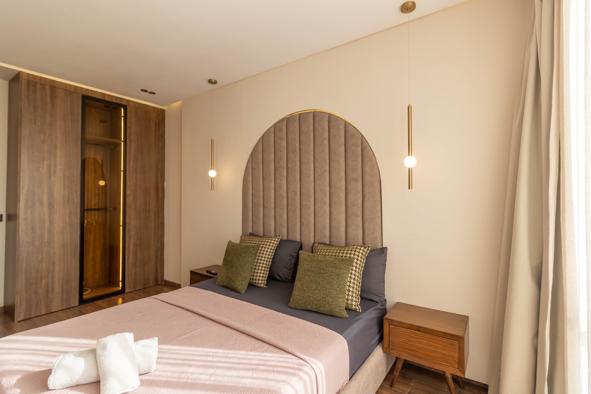 Verfijnde nachtruimte met een mix van hout en zachte tinten, comfortabel bed, voorbereid voor je aankomst, rustige en intieme sfeer.