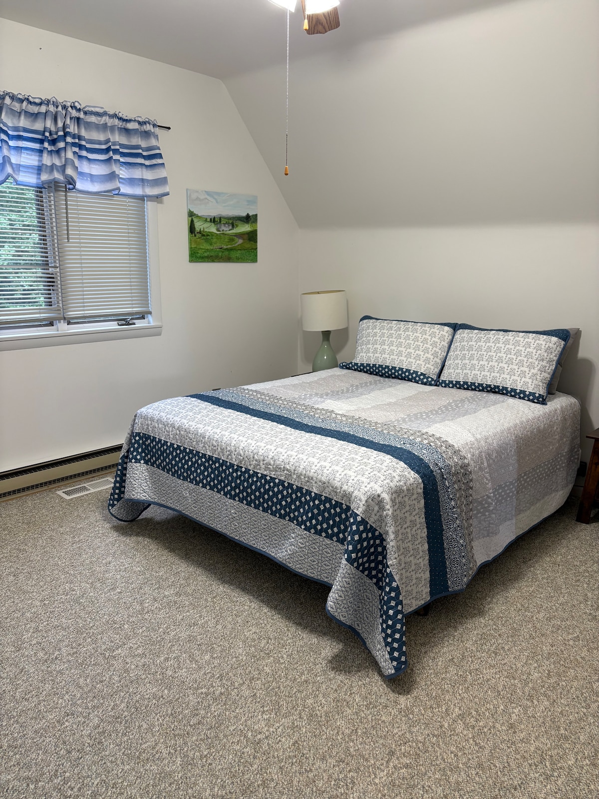 Chumba cha kulala juu na kitanda cha ukubwa wa malkia.  Dirisha linaangalia ua wa nyuma.  Chumba kikubwa chenye droo na kabati.