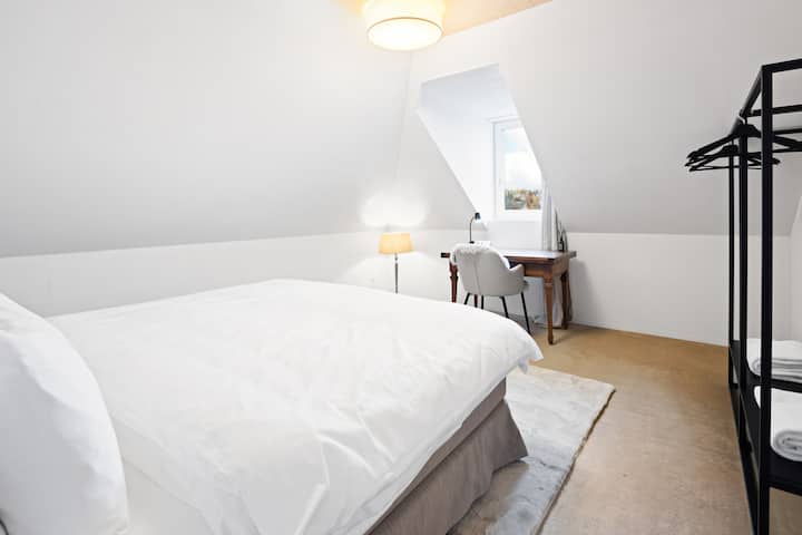 חדר שינה מרווח עם מיטת קפיצים נוחה, הרבה אור יום ומקום עבודה נחמד עם נוף. מושלם לשינה טובה ולחופשה עבודה פרודוקטיבית באווירה מודרנית.