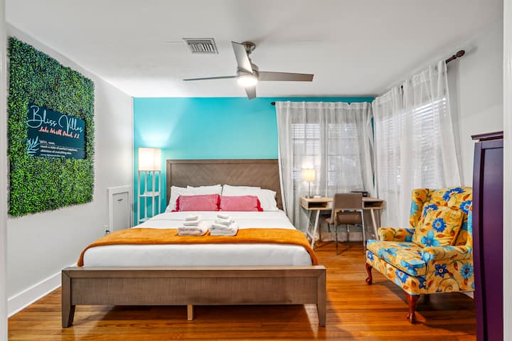 The king sized bed has a comfy mattress covered in white cotton linens.