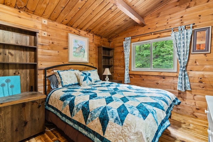 A restful queen bedroom with forest views and fresh linens