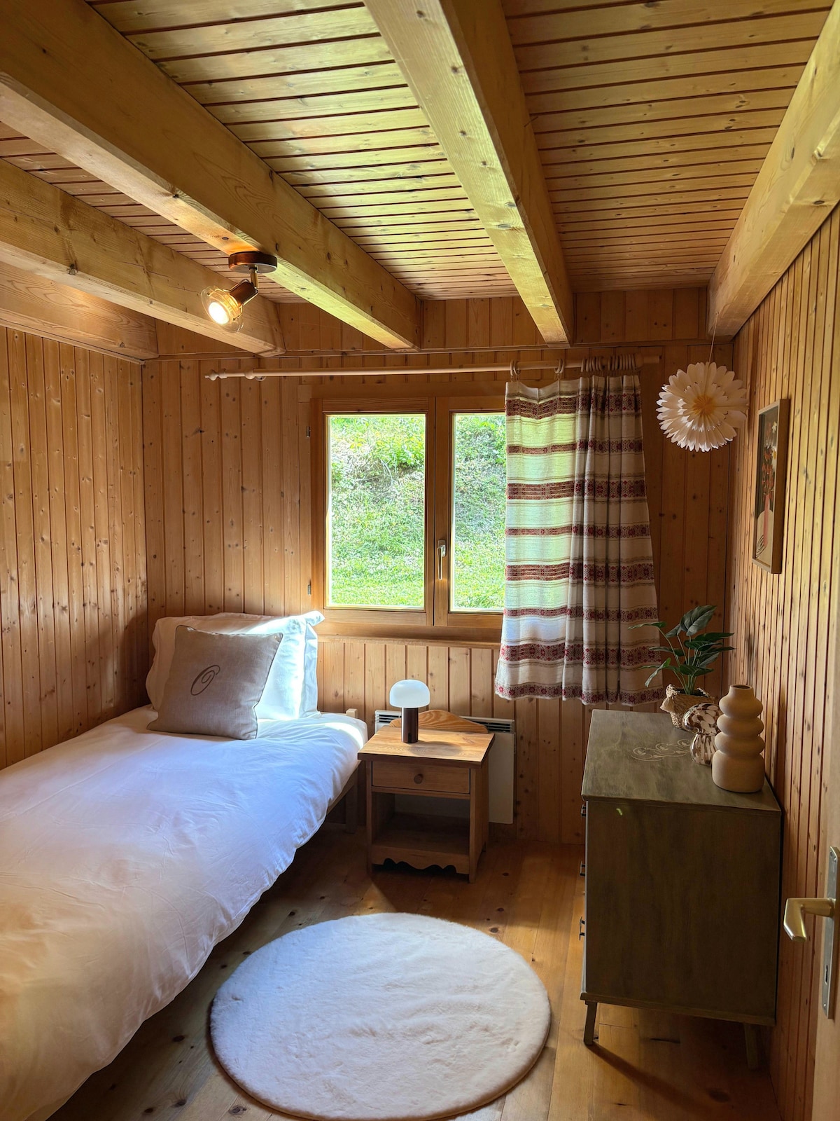 Acogedor y luminoso: Una habitación de estilo chalé, con una cama individual, ideal para descansar después de un día en la montaña.