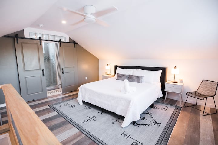 A calm, airy upstairs primary king sized bedroom with bathroom - designed for restful nights 