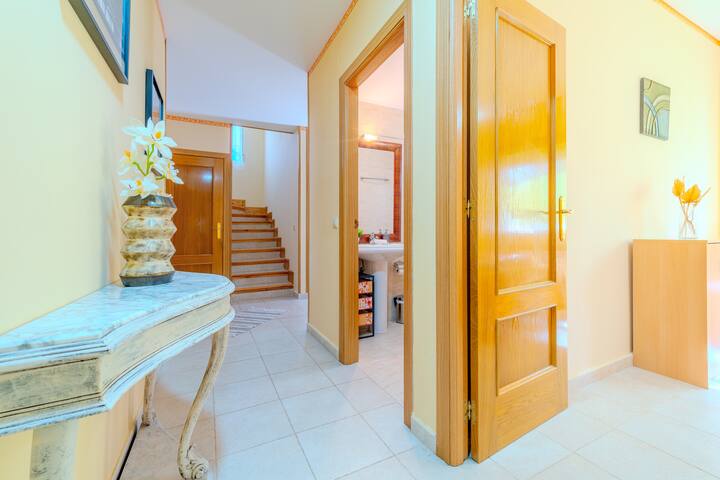 Distribuidor con consola y escalera al fondo: casa amplia y bien comunicada.