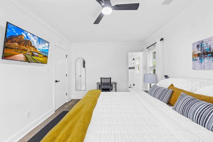 מיטת קינג סייז מפוארת עם תחנת טעינה על שולחנות צד