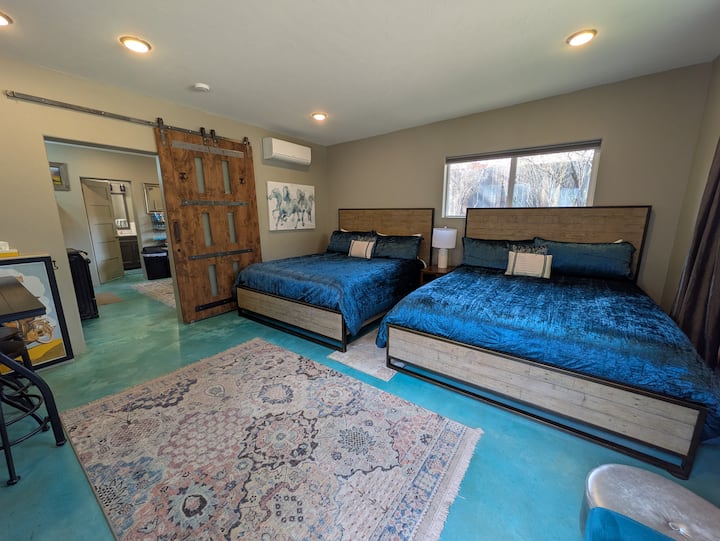 The bedroom area of the north cottage. These California king size beds are SO cozy!!