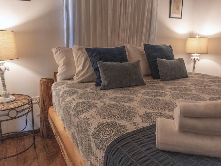 Blackout shades and beautiful warm lighting that compliments the rustic floors.