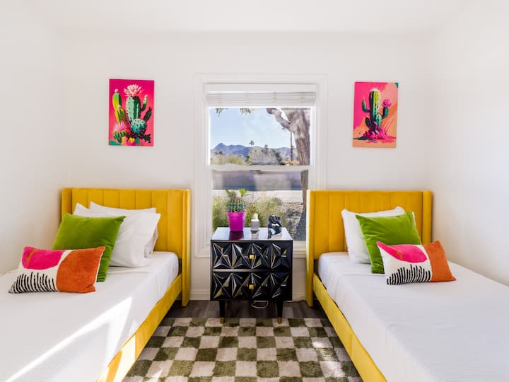 Vibrant and cheerful sleeping space 
Two cozy twin beds with colorful décor and bright accents create a playful, welcoming room perfect for kids, friends, or extra guests.