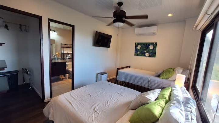 Guest Room (Full Bed + Twin). Designed for flexibility, this guest room combines a full bed with a twin— ideal for friends, family, or children sharing the space in comfort. Guest room located on the lower level.