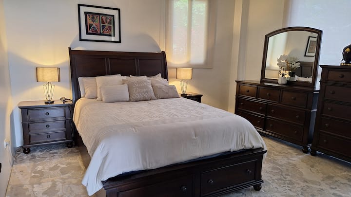 Master Bedroom Retreat (Queen Bed). Elegant and serene, the master bedroom offers a cozy haven with warm lighting, refined furnishings, and restful comfort for sweet dreams.