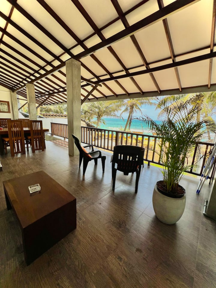 Sea-facing balcony with comfortable seating.