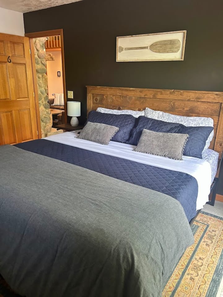 The spacious master bedroom has a king bed, closet, and private deck access through patio doors. 