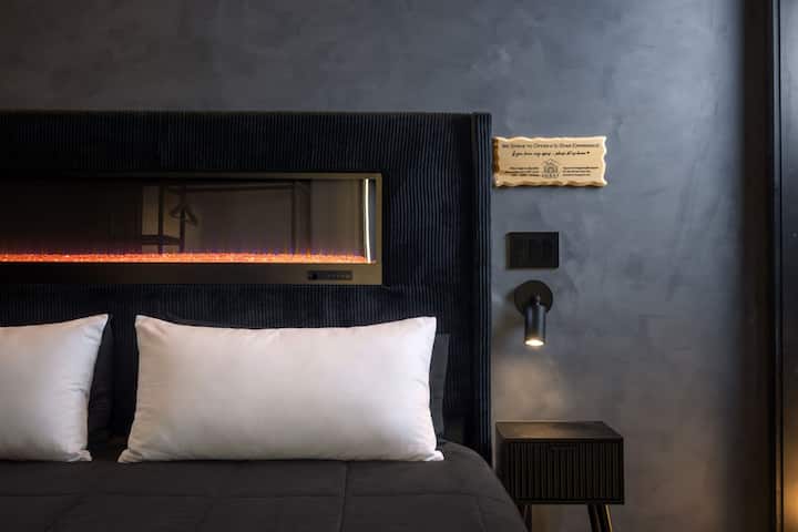 A built-in fireplace set into the headboard gives this bedroom a warm, intimate glow, a special touch that makes settling in feel especially cozy.