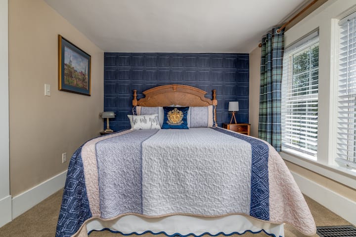 Queen size bed in this upstairs bedroom overlooking the view of the street. Probably the sunniest room in the house!