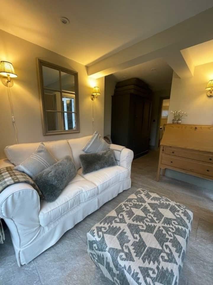 This versatile room is situated off the kitchen and can be used as a workspace, a second bedroom with the use of the sofa bed or lounge/ sun room with direct access to the patio. 