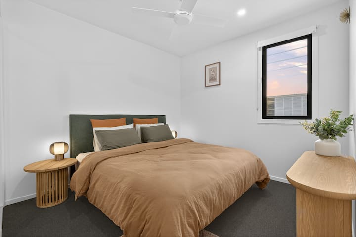 Bedroom 2 featuring a luxurious king size bed, ducted air conditioning and ceiling fan.