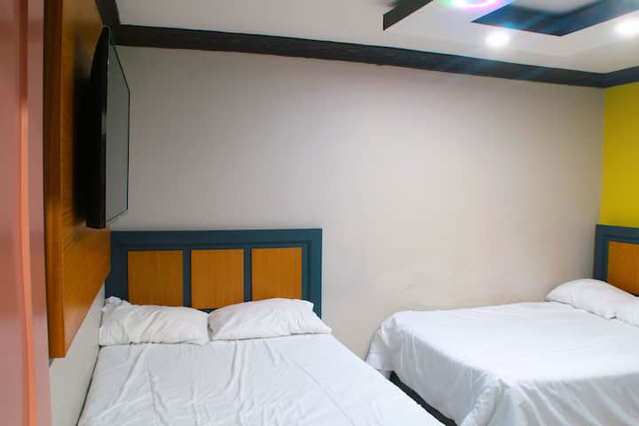 Dhomë e pajisur me dy krevate dopio, ideale për familje ose grupe. Hapësirë funksionale, me ajër të kondicionuar dhe televizor për rehati të përditshme.