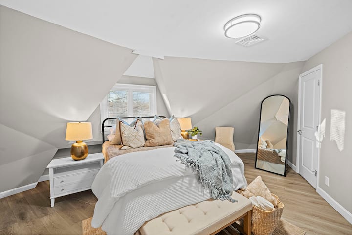 This primary bedroom is located on the second floor (yes, there is another primary bedroom but on the first floor).  This room features a queen bed, comfy bedding, nightstands, floor length mirror and work space.