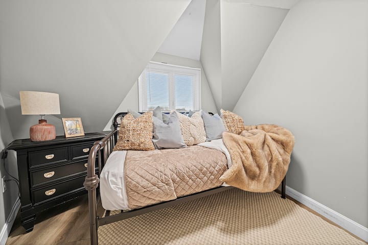 This bedroom features a double bed, dresser for additional storage and closet. This room has hallway access to the full bathroom on this floor.