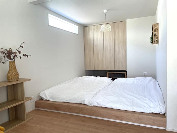 座椅子とテーブルを移動して布団を敷きます。セミダブルの布団を2つ敷くことができます。ロールスクリーンあり。