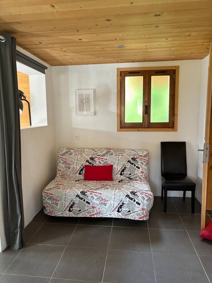 Zona al piano inferiore con divano letto matrimoniale e tende oscuranti