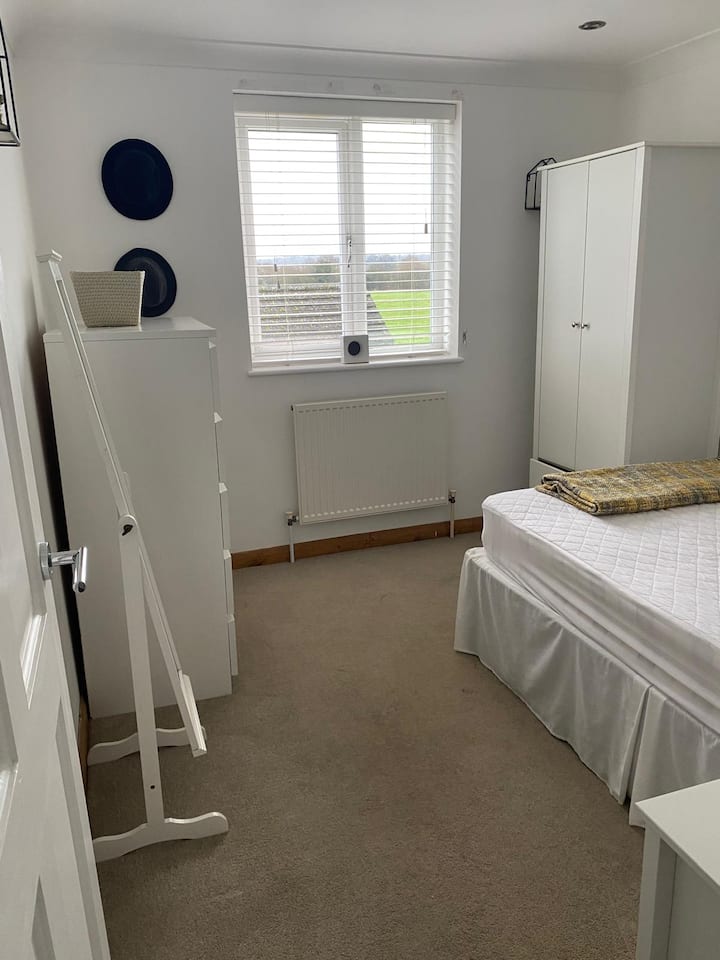 Bedroom Retreat: Enjoy restful nights in this inviting room with soft linens and warm decor!