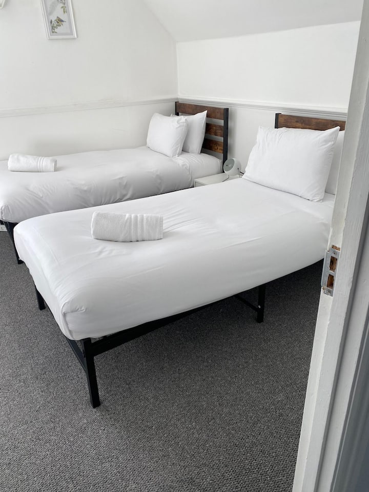 Bedroom Retreat: Bright and airy room with plush bedding and stylish decor, ready for your getaway!