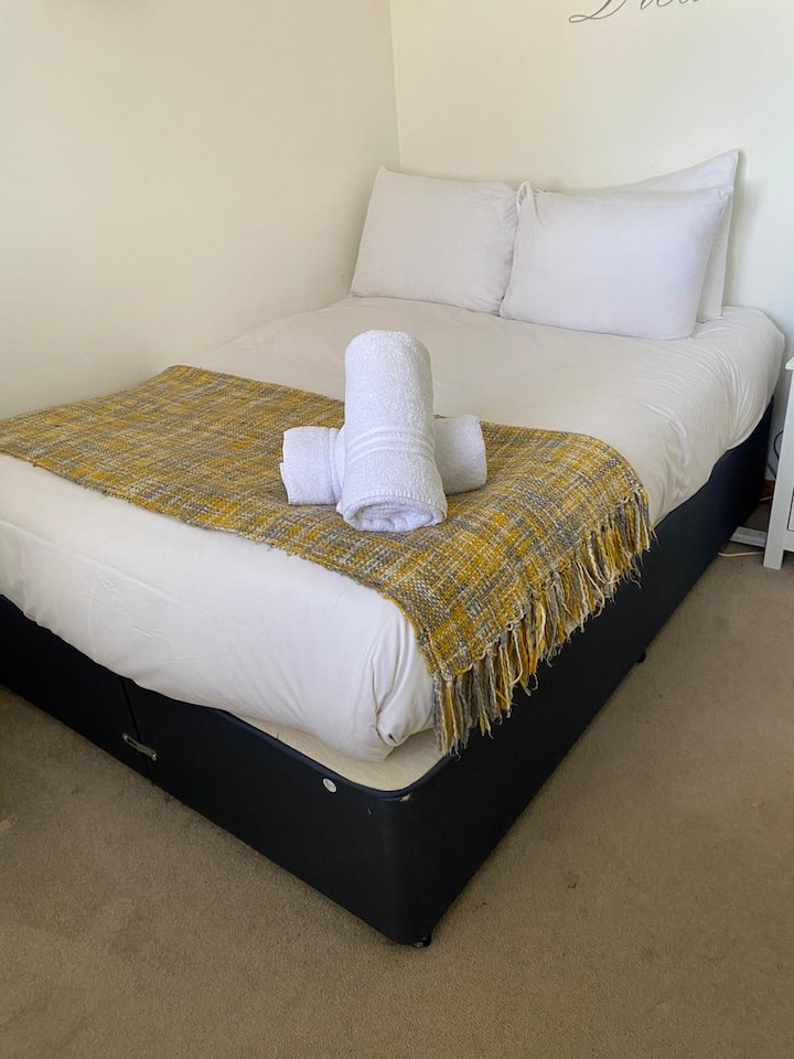 Bedroom Retreat: Bright and airy room with plush bedding and stylish decor, ready for your getaway!