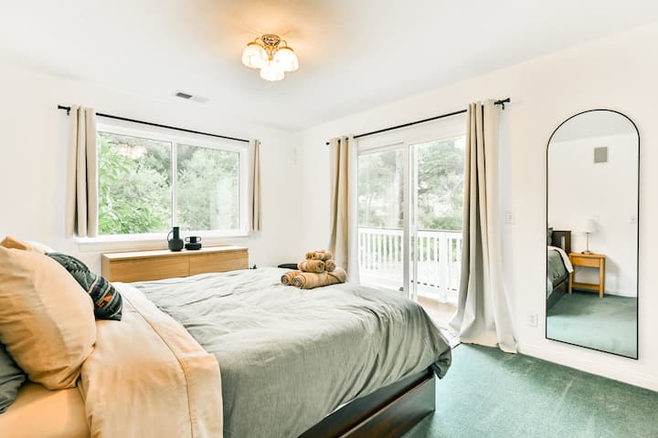 Bedroom 3 (Queen) has a sliding door that leads out to a balcony that connects to the back deck