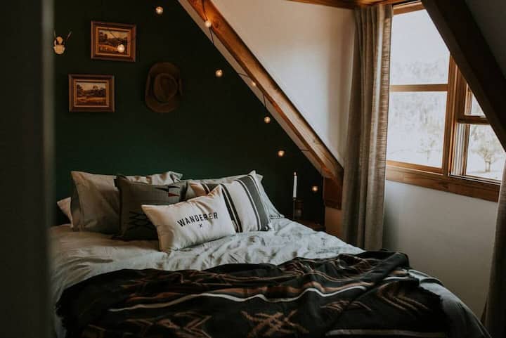 The second bedroom, dubbed 'The Green Room' offers a cosy queen bed.