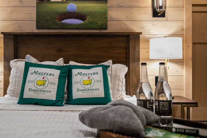 Inviting bedroom with cozy seating and warm cabin charm.
