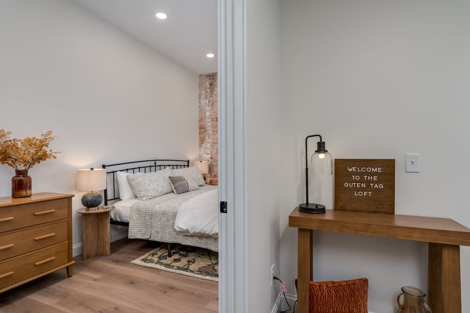 King bed with cotton sheets in a fragrance-free New Ulm loft