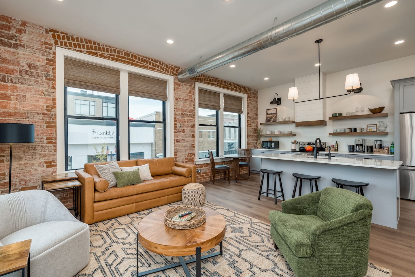 Oversized kitchen island in a renovated New Ulm loft with exposed brick