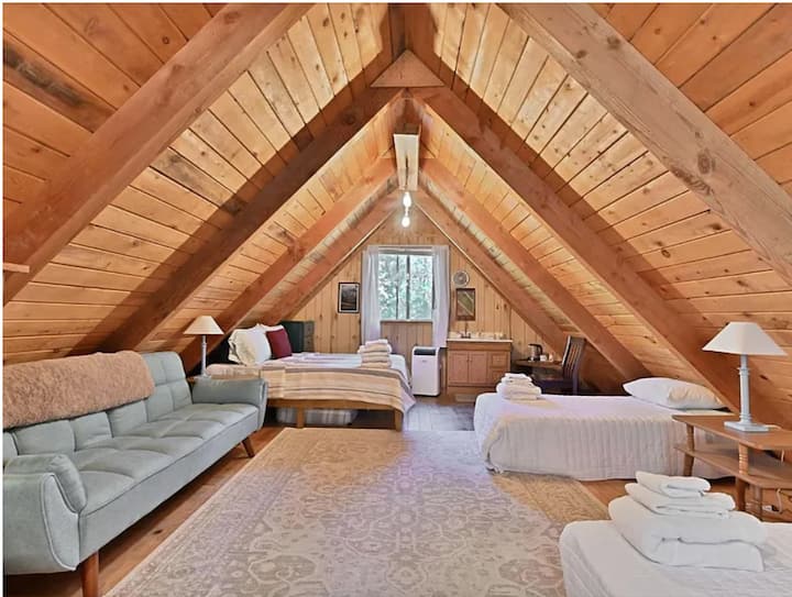 This peaceful space is located in the top level of the bunkhouse, with the game room and full bathroom downstairs. Equipped with an A/C unit and a wall mounted gas heater for year-round comfort.