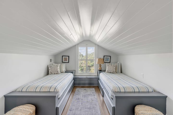 An adorable third floor space with its own full bath. There is a seating area with it along with the best view in the house from the third floor patio!