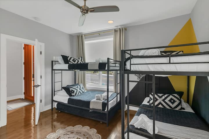 Fun bunk room with queen-over-queen beds, stylish décor, ceiling fan, and natural light. Perfect for groups or kids, offering a comfortable and playful space to unwind after a day of exploring.