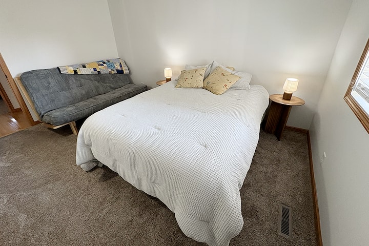 This bedroom sleeps 4 with one queen bed and a full-size pull-out futon. 