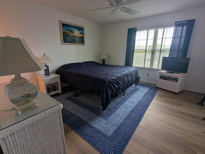 King sized bed, dresser, FireTV, ceiling fan, large closets