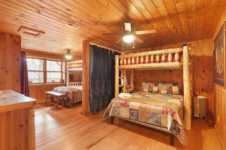 Kids and families love this fun bunk-and-bed setup. There’s plenty of room to spread out, play, and sleep comfortably — and the warm wood finishes make it feel like a true cabin hideaway.