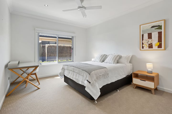 Bedroom 3 – Queen bed, walk-in robe, and a dedicated desk space for remote work or study.