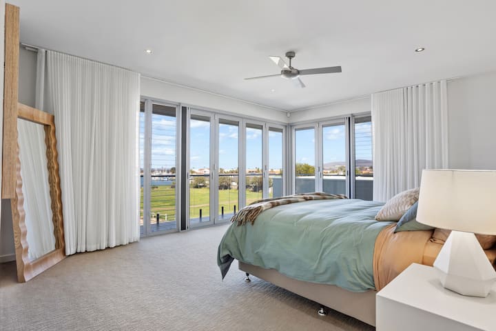 Flooded with natural light and framed by floor-to-ceiling glass, the master suite offers a king bed, private balcony, a huge walk-in robe, and a grand ensuite, the perfect blend of comfort and indulgence.
