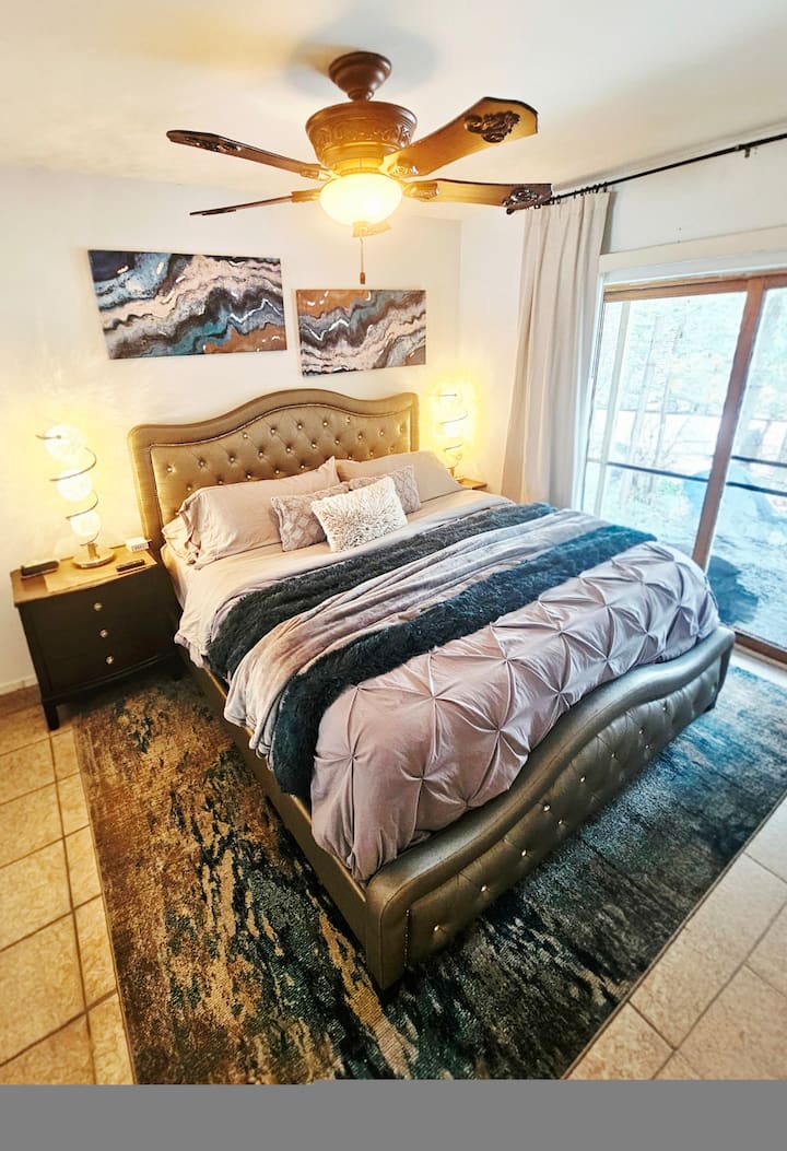 Relax in the luxurious King Size Bed with panoramic sliding door views of Big Elbow Lake. Enjoy comfort with a ceiling fan and a full closet with a tall dresser—unpack your suitcase and settle in!