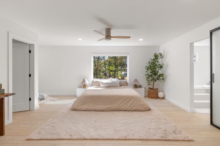 King bed on the second floor in a large master room with a luxurious ensuite bathroom and cozy entertainment nook.