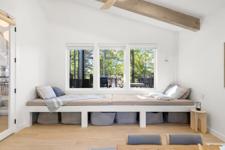 This Japanese-inspired tea room features two twin XL futon mattresses. They are each 4" thick and comfortable for sleeping or lounging in. This light-filled room features a kotatsu table, record player and sliding door access to the backyard.