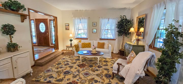 The north view of the living room shows the seating area, hide-away queen bed, and front entrance door.