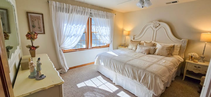 With French Country warmth, the playfully named Queen’s Room offers a twist — it features a spacious king bed!