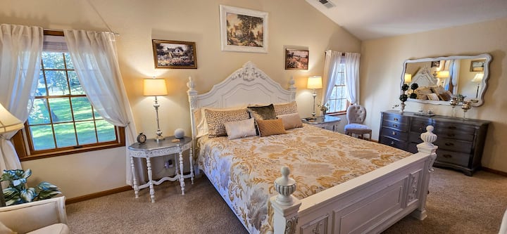 A gentle touch of French Country style adds unique elegance to the master bedroom suite.