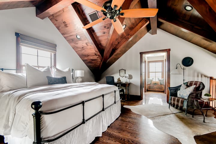 The second-floor suite is tucked away in the loft area. This space includes a private full bathroom, large walk-in closet, window seat and vanity space.