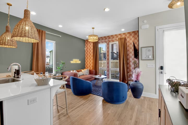 Living Room | Open Layout | Statement Lighting
Bright open-concept living area with warm tones, eye-catching light fixtures, and direct access to the patio for easy indoor-outdoor flow.