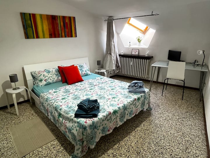 Habitación luminosa con una cama cómoda y un espacio exclusivo para trabajar o estudiar